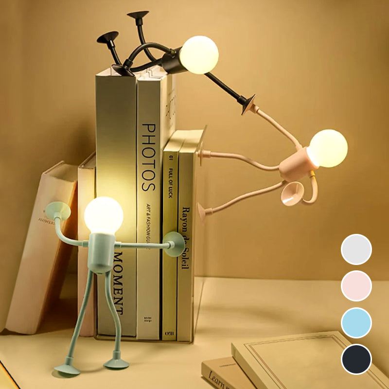 Drei leuchtende Figurenlampen in Schwarz, Rosa und Mintgrün stützen sich an einem Bücherstapel ab; rechts vier Farbpunkte zur Auswahl. 5