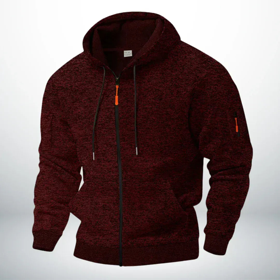 Dieselbe Kapuzenjacke in meliertem Weinrot, frontal von schräg gezeigt, mit orangefarbenem Zipper und Ärmeltasche. 2