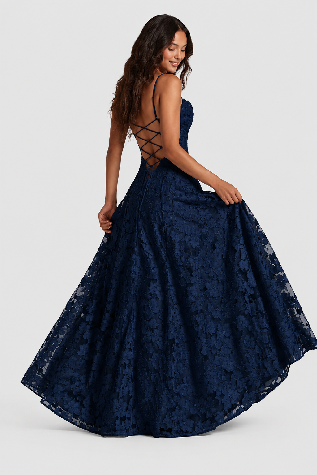 Marineblaues Spitzenkleid von hinten mit Kreuzschnürung am Rücken, das Model hält den weiten Rock seitlich fest. 5