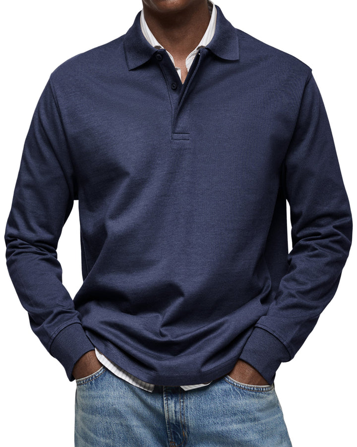 Langarm-Poloshirt in Dunkelblau an einem Model, Frontansicht mit Kragen, kurzer Knopfleiste und gerippten Ärmelbündchen. 3
