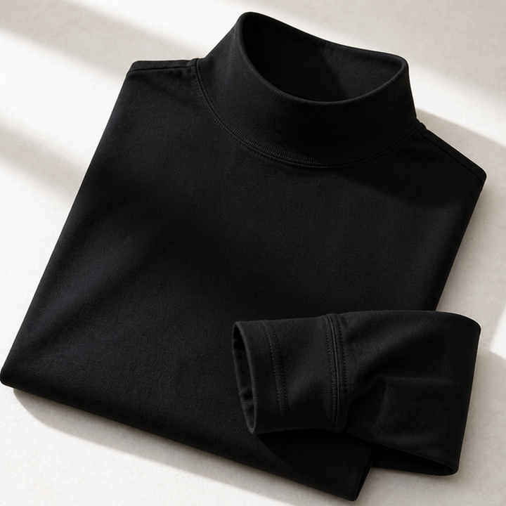 Zusammengelegtes schwarzes Langarmshirt in Nahaufnahme mit gerippter Kragenpartie und sichtbarer Naht am Ärmelsaum. 5