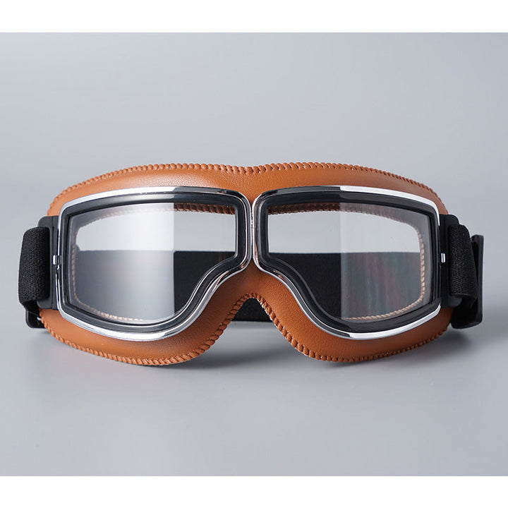 Frontansicht der Brille mit hellbrauner Lederpolsterung, farblosen Gläsern und Chromrahmen. 7