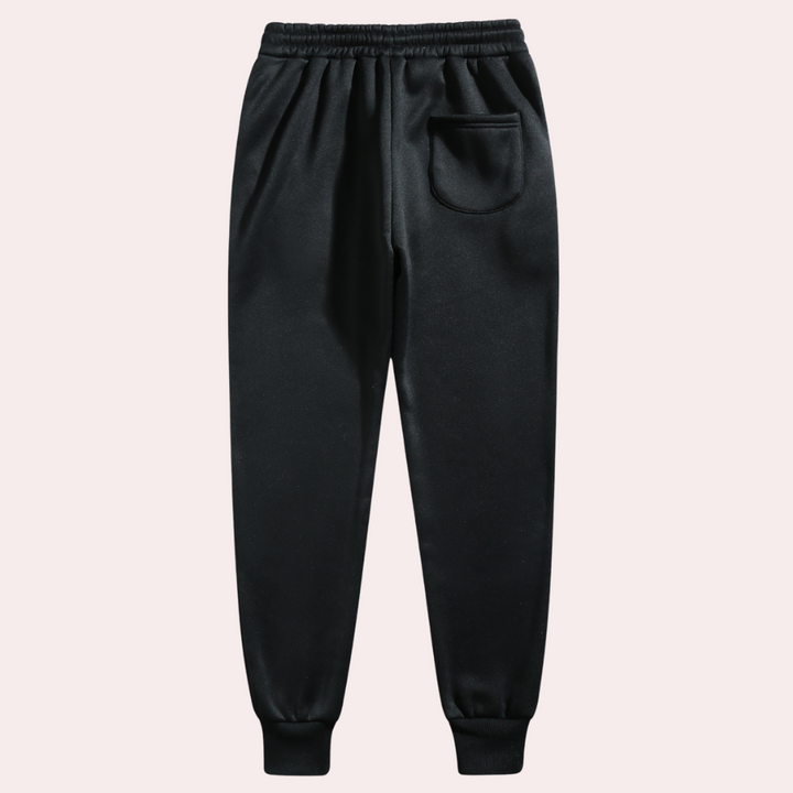 Schwarze Jogginghose, elastischer Bund, Seitentasche, Baumwolle, Herrenmode, bequem.