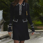 Damenkleid schwarz mit weißen Akzenten, langärmelig, Knopfleiste, elegantes Design.