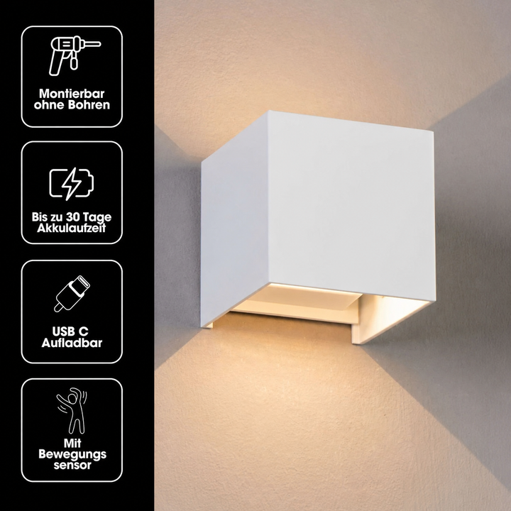 Weiße Würfelleuchte an einer Wand mit vier Symbolen links für Montage ohne Bohren, Akkulaufzeit, USB-C-Aufladung und Bewegungssensor. 19