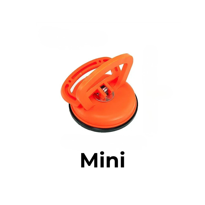 Kleiner orangefarbener Saugheber mit Klappgriff und schwarzem Gummirand, einzeln vor weißem Hintergrund. 6
