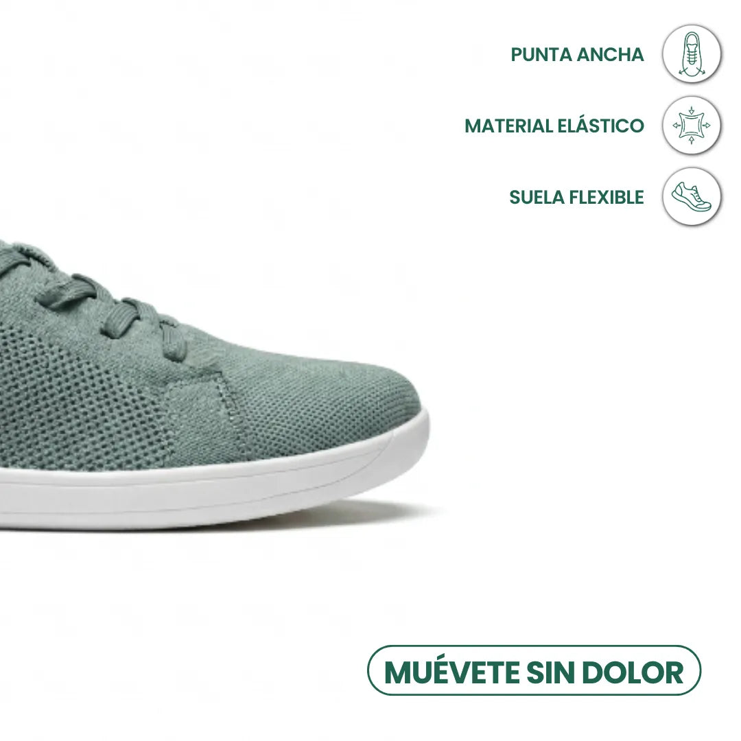 Detailansicht der breiten Zehenbox eines graugrünen Mesh-Sneakers mit weißer Sohle, daneben Symbole für flexible Sohle und dehnbares Material. 32