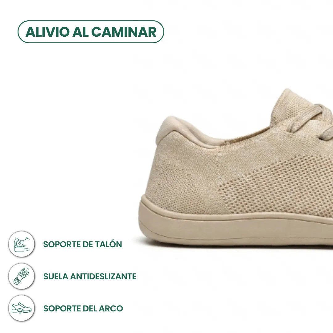 Beiger Sneaker, Fersenpartie im Ausschnitt, mit Symbolen für Fersenhalt, rutschfeste Sohle und Fußgewölbeunterstützung. 4