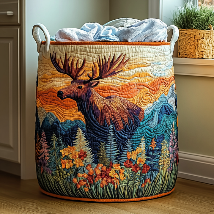 Gesteppter Korb mit Elchmotiv vor orangem Himmel und blauen Bergen, Blumenwiese unten, orange Einfassung, gefüllt mit hellblauen Handtüchern. 6