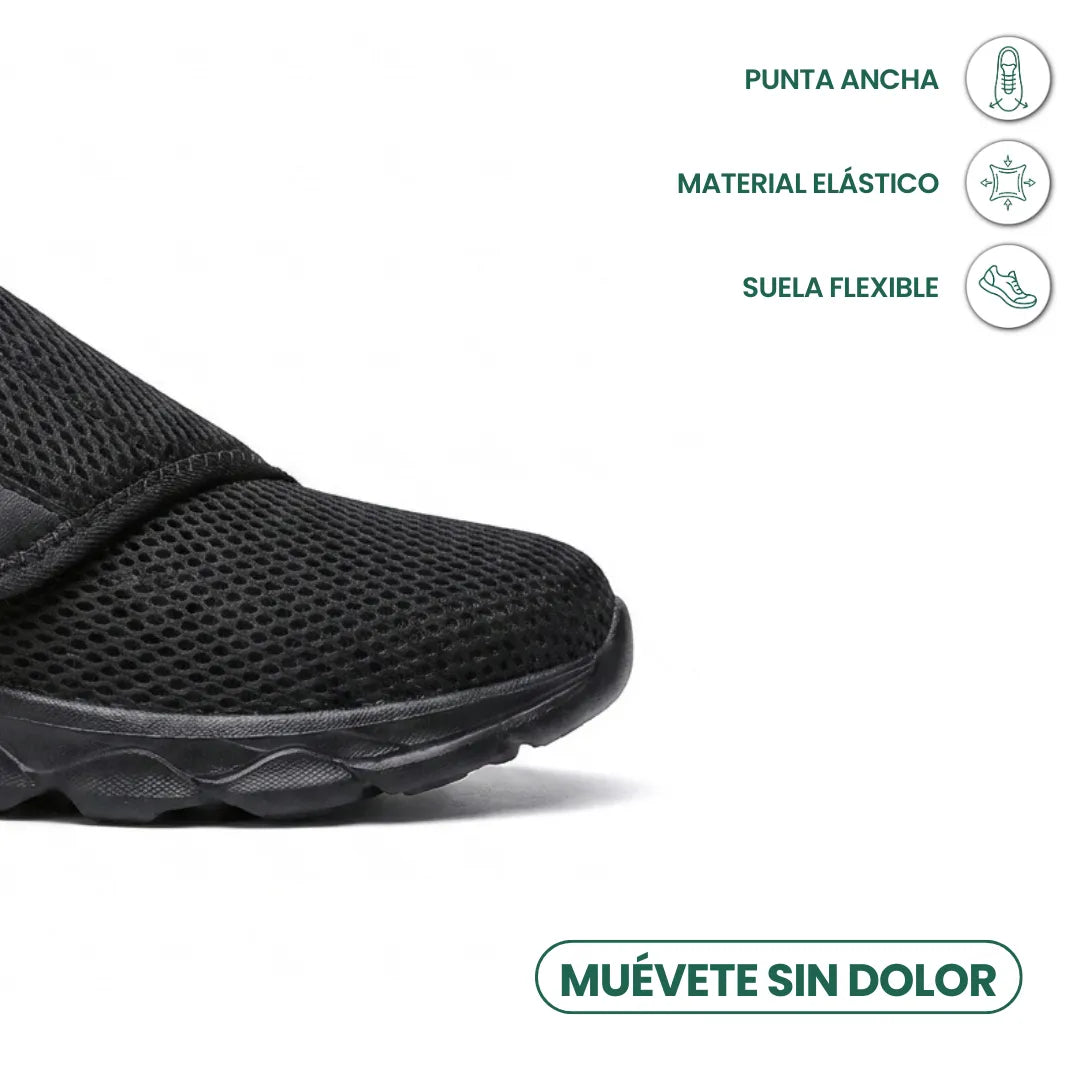 Nahaufnahme der breiten Spitze des schwarzen Netzschuhs, daneben Symbole für weite Spitze, elastisches Material und flexible Sohle. 14