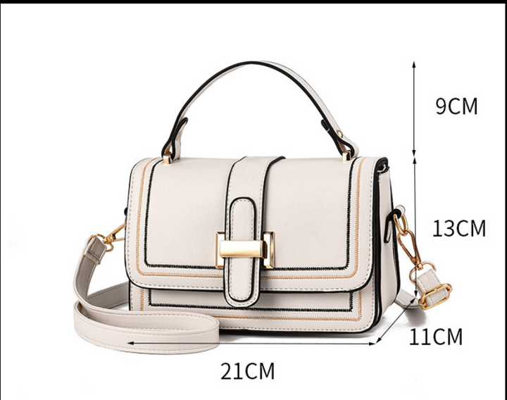 Cremeweiße Tasche von vorn mit eingezeichneten Maßangaben zu Höhe, Breite, Tiefe und Griffhöhe. 9