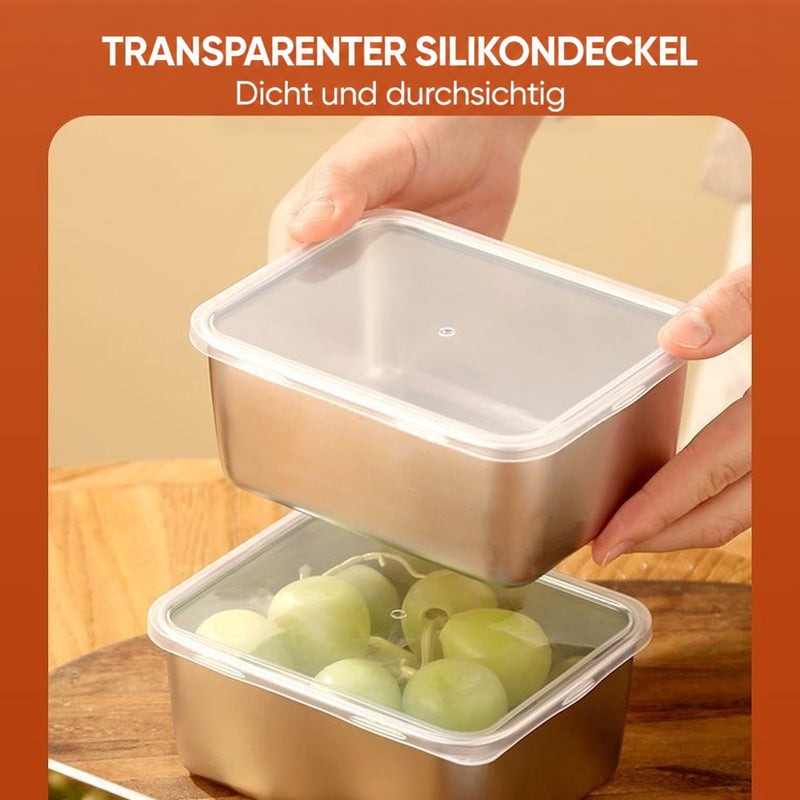 Hände setzen einen durchsichtigen Deckel auf eine Edelstahlbox, darunter eine weitere Box mit Trauben, ebenfalls mit transparentem Deckel. 9