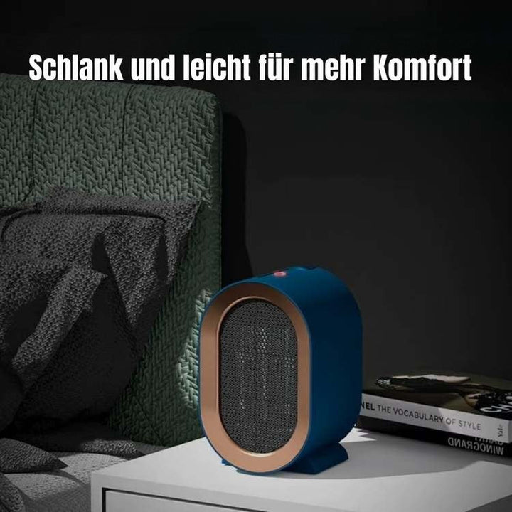 Blauer Heizlüfter mit roter Betriebsanzeige auf einem weißen Nachttisch neben Bett und Büchern in dunklem Raum 2