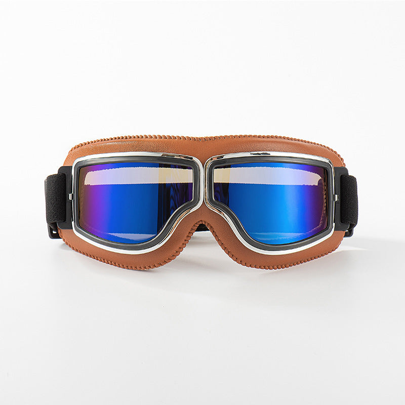 Frontansicht der Brille mit hellbrauner Lederpolsterung und blau verspiegelten Gläsern vor weißem Hintergrund. 9