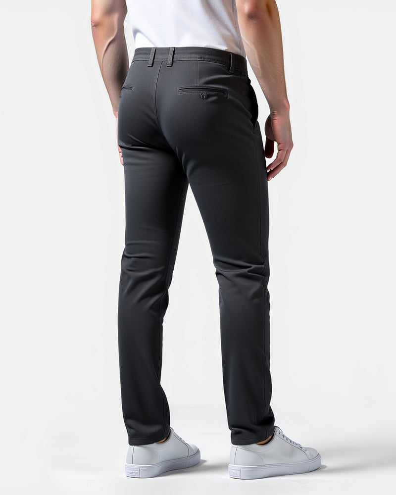 Rückansicht der dunkelgrauen Chino mit aufgesetzten Gesäßtaschen, getragen mit weißem Shirt und weißen Sneakern. 8