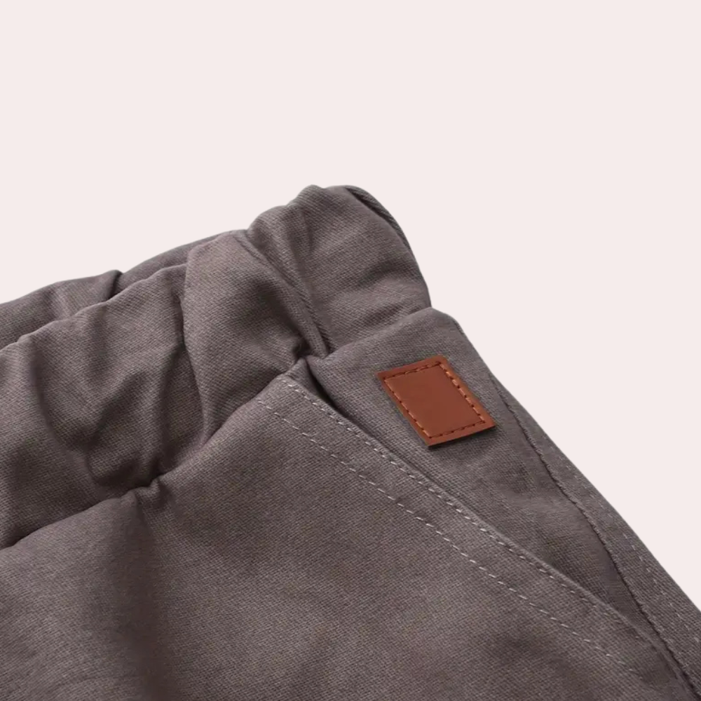 Graue Baumwollhose mit elastischem Bund und braunem Lederetikett, bequeme Freizeitkleidung.