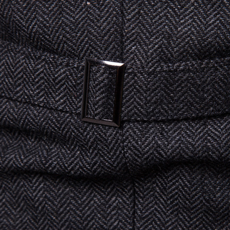 Dunkelgrauer Tweed-Stoff mit Fischgrätmuster und rechteckiger Metallschnalle.