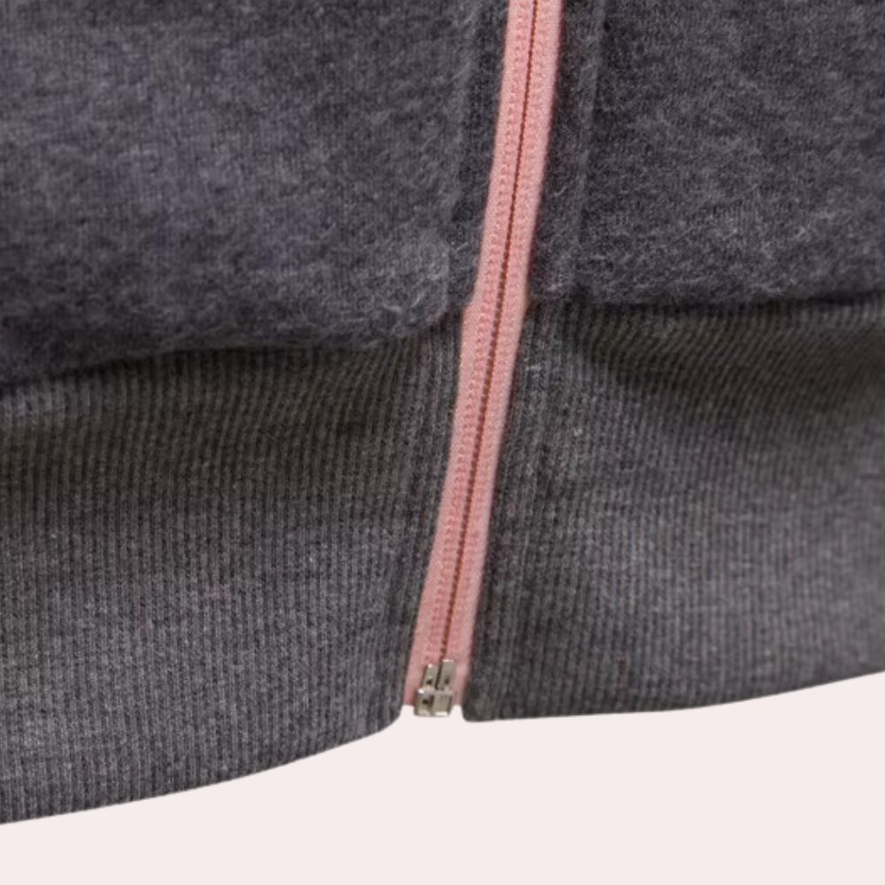 Grauer Wollpullover mit rosa Reißverschluss, weiches Material, modisches Design.
