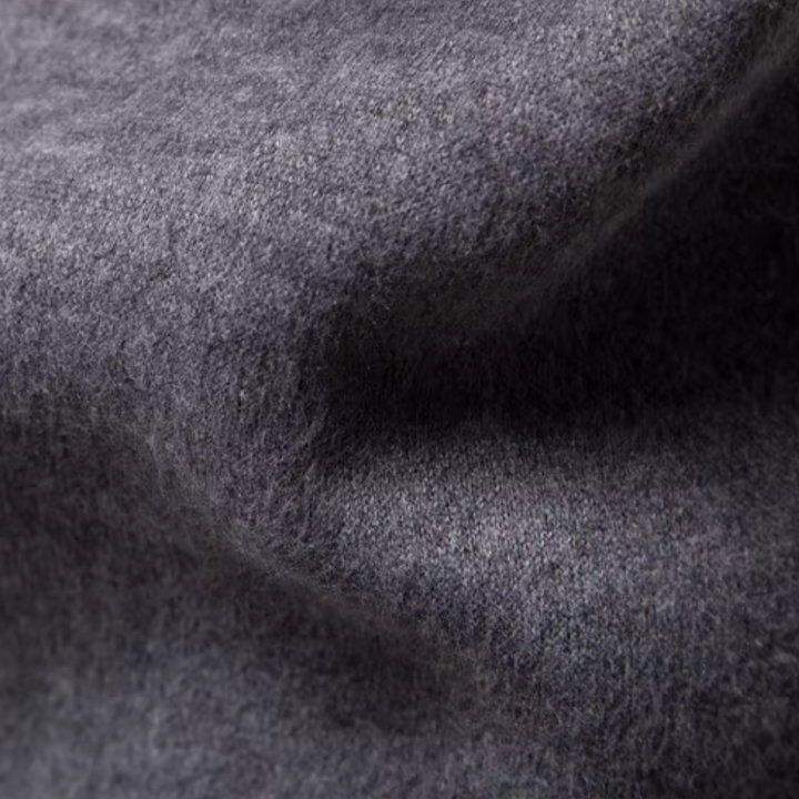 Grauer Wollstoff, Nahaufnahme, weiche Textur, hochwertiges Material, ideal für Bekleidung.