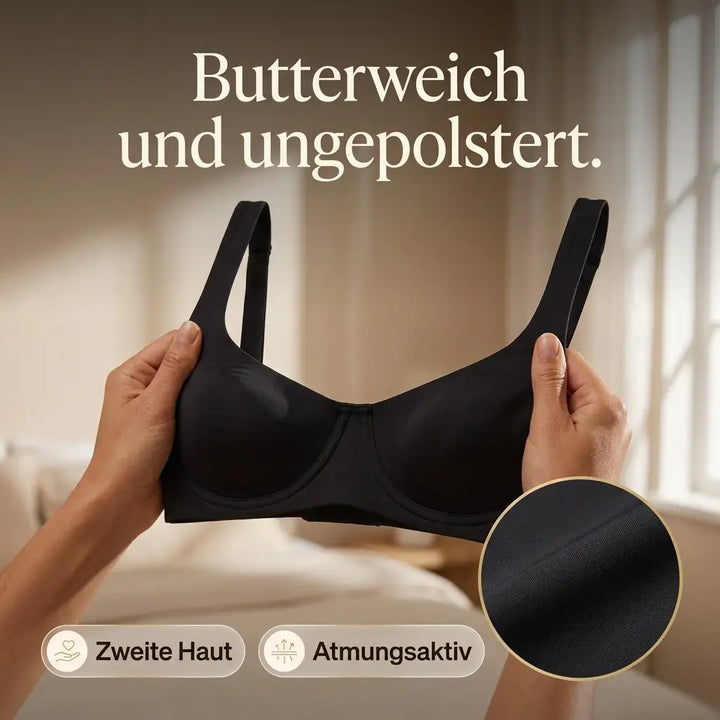 Zwei Hände halten den schwarzen ungepolsterten BH vor einem hellen Fenster, ein Kreis zeigt die glatte Stoffstruktur im Detail. 9