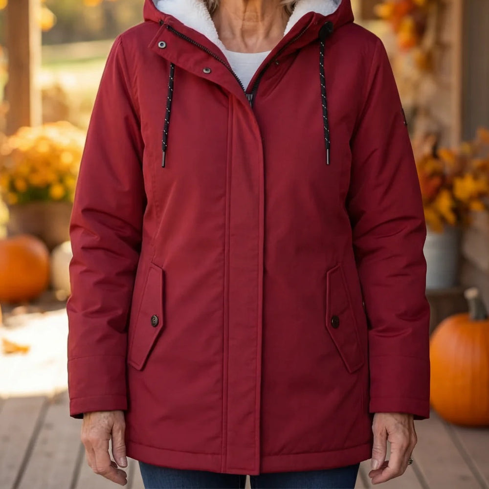 Roter Parka mit Kapuze und Kordelzug in Nahaufnahme, getragen vor herbstlicher Kulisse mit Kürbissen 2