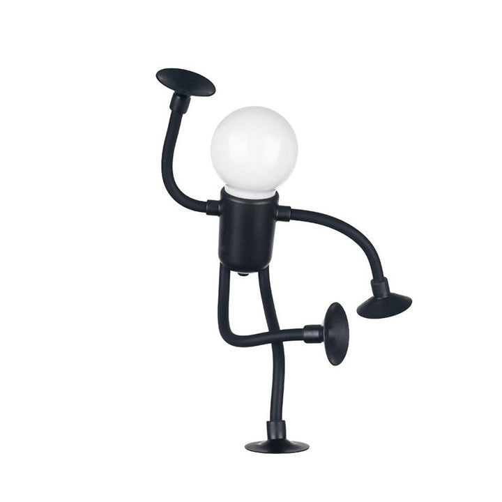 Schwarze Figurenlampe mit Kugelkopf, ein Arm erhoben und ein Bein angewinkelt, steht auf einem Saugnapf vor weißem Hintergrund. 15