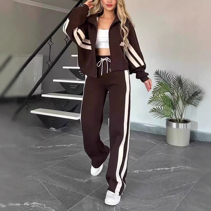 Set in Dunkelbraun mit weißen Streifen, Model geht in weißen Sneakern auf die Kamera zu, Hose mit weißer Kordel. 8