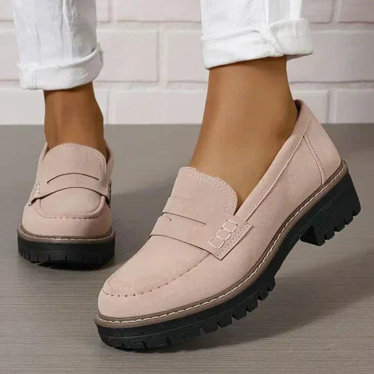 Zartrosa Loafer mit Zierlasche und schwarzer Profilsohle, getragen zu weißer Hose mit umgeschlagenem Saum. 8