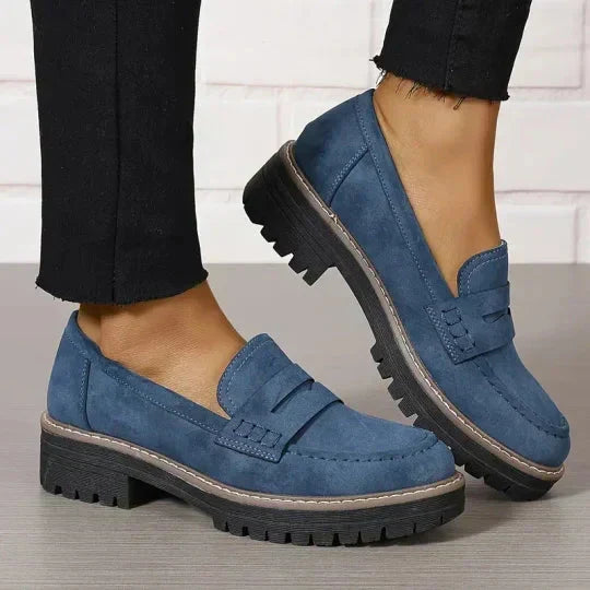 Blaue Wildleder-Loafer mit Plateausohle, getragen zu schwarzer Hose mit ausgefranstem Saum, Seitenansicht beider Schuhe. 9