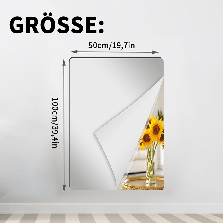 Rechteckige Spiegelfolie an einer Wand mit abgelöster Ecke und Sonnenblumen im Spiegelbild, Maßangaben für die schmalere, höhere Variante. 12