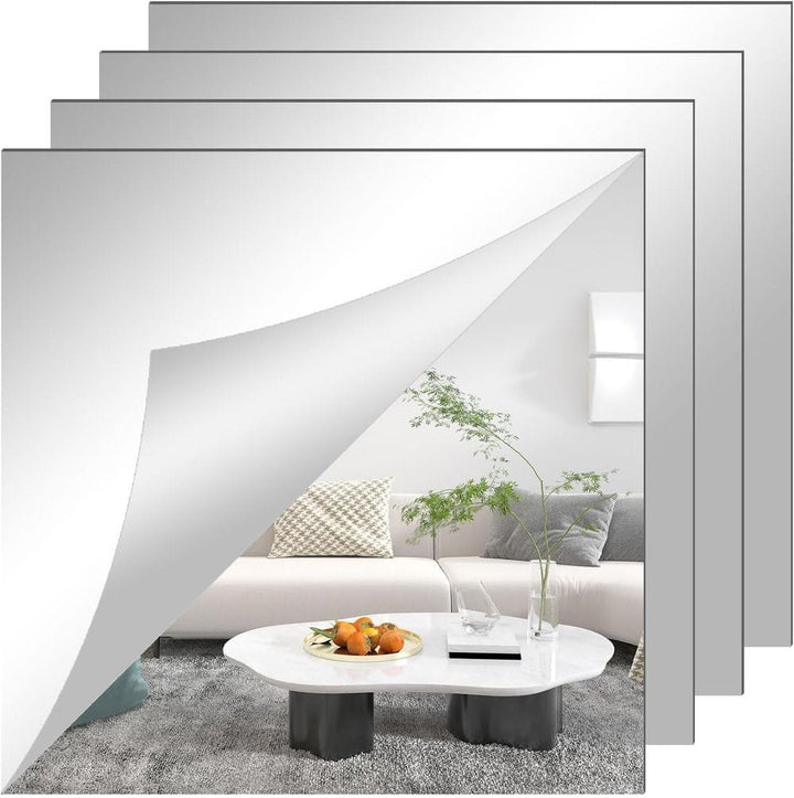 Vier quadratische Spiegelfolien-Zuschnitte übereinander, bei der vorderen ist eine Ecke abgezogen und zeigt ein Sofa mit Couchtisch. 3